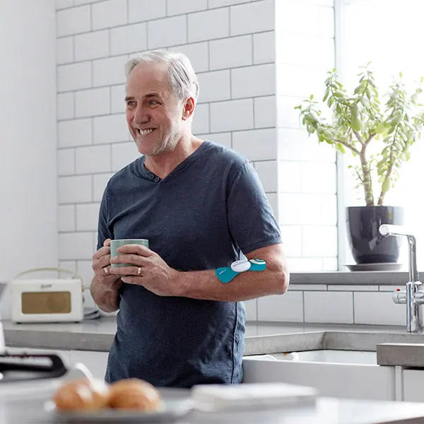 Man wearing PainGone Easy on his arm in the kitchen