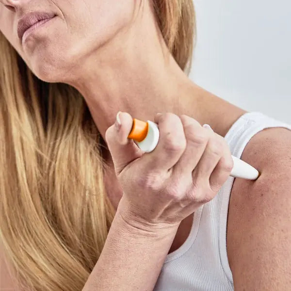 Woman applying PainGone Plus to her shoulder