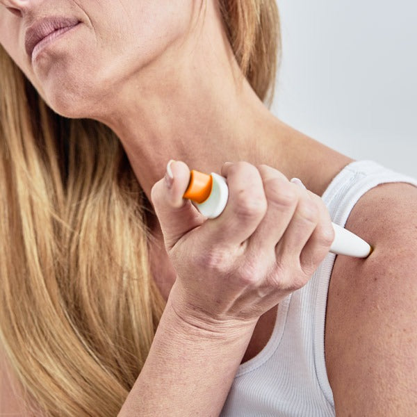 Woman using Paingone Plus on the shoulder